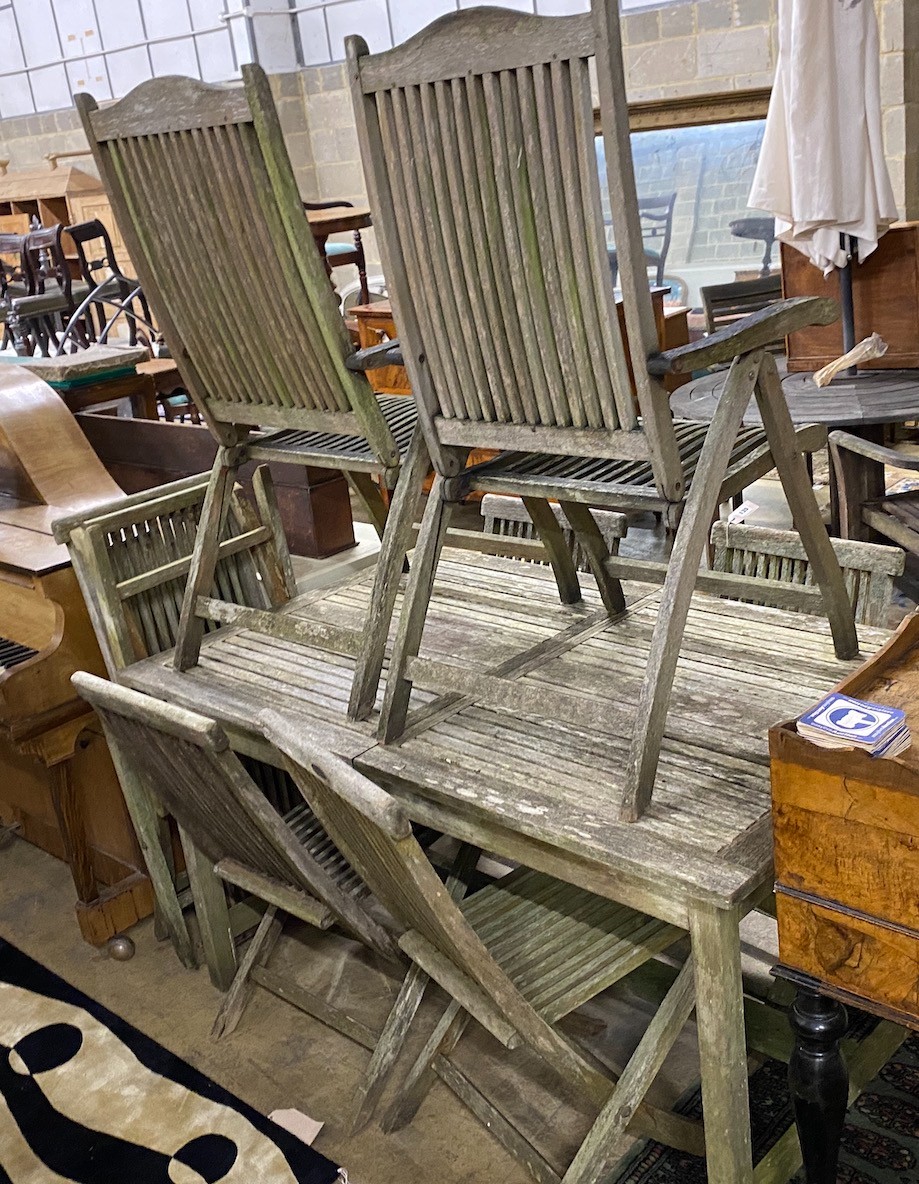 A rectangular weathered teak extending garden table, length 192cm extended, width 89cm, height 76cm together with eight teak folding garden chairs, two with arms